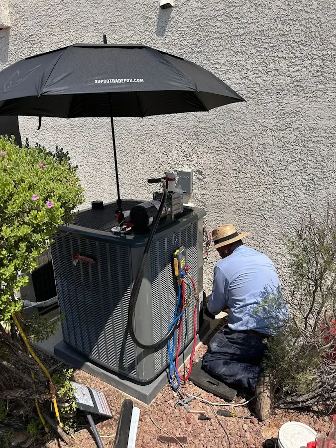 HVAC technician performing outdoor AC maintenance in Edinboro